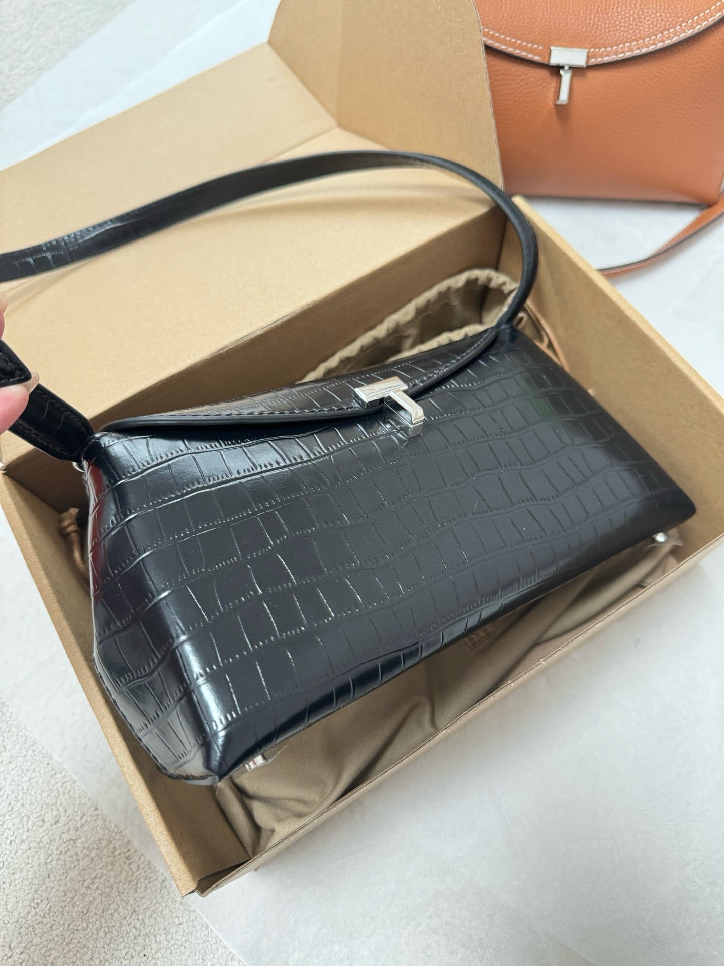 Tot T-Lock crocodile-effect leather clutch bag